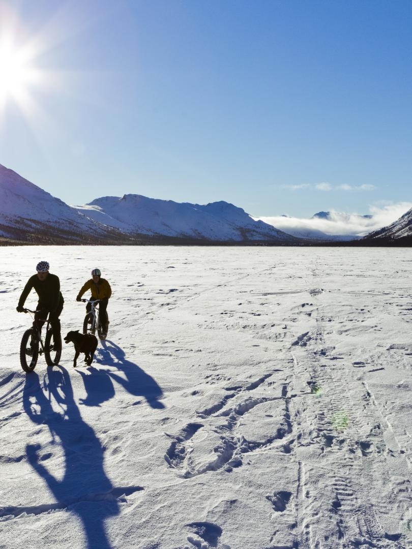 Fat biking across a frozen snowy lake